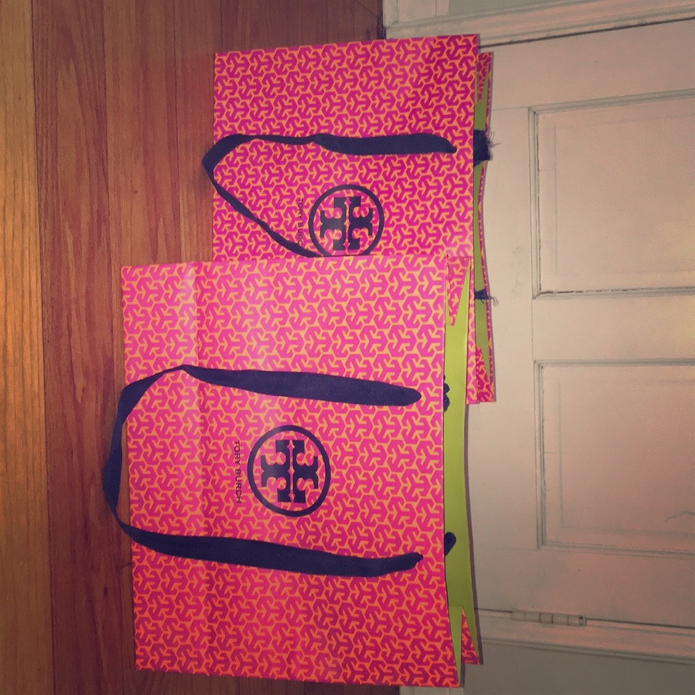 Two Tory Burch shopping bags.